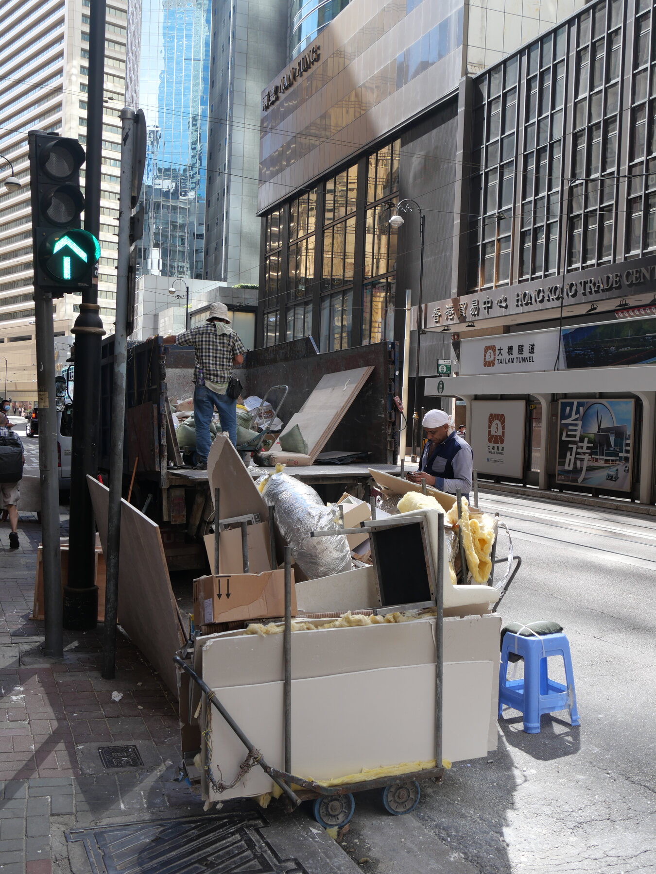 Workers loading renovation debris into a hauling truck